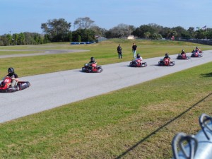 A group in go-karts zoom along the track